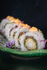 Delicious sushi rolls with sauce on marble tray