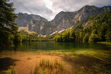 Amazing scenery under the huge mountains. Glaciers cover with snow and unique magical lake in Austrian Alps, Europe.