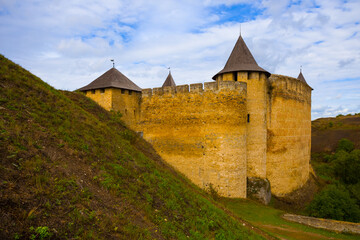 Fototapeta na wymiar closeup old medieval castle among green hills, open air museum scene