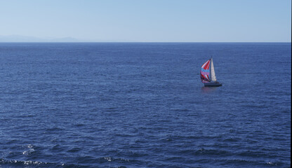 Sailboat sailing on the blue sea.