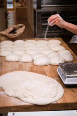 Photo detail of a baker's hands working the bread dough