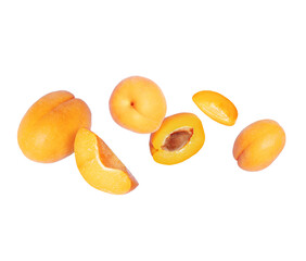 Ripe whole and sliced apricots close up in the air isolated on a white background