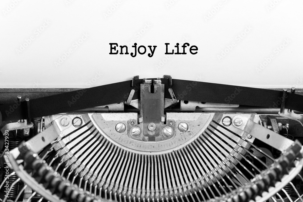 Fototapete enjoy life phrase closeup being typing and centered on a sheet of paper on old vintage typewriter me