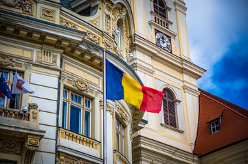 Sibiu, Romania - September 16 2022: Municipiului Sibiu or Sibiu City Hall with waving Romanian flag