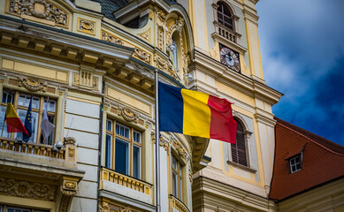 Sibiu, Romania - September 16 2022: Municipiului Sibiu or Sibiu City Hall with waving Romanian flag