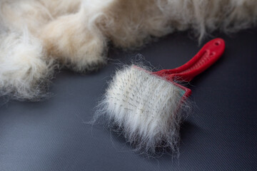 light wool on a comb on a dark background