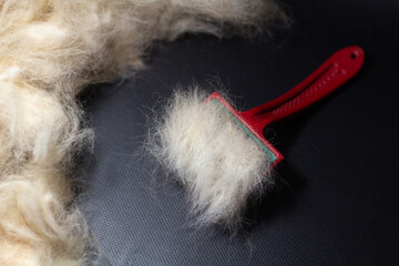 light wool on a comb on a dark background