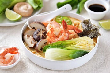 Asian spicy soup with noodles, shiitake mushrooms, shrimp and bok choy. 