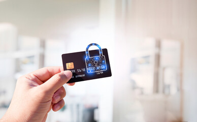 Close up of man hand holding credit or debit card with padlock, protection of financial transactions, copy space, Financial security technology concept. - obrazy, fototapety, plakaty