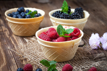 Blackberries, raspberries and blueberries in a waffle bowls.