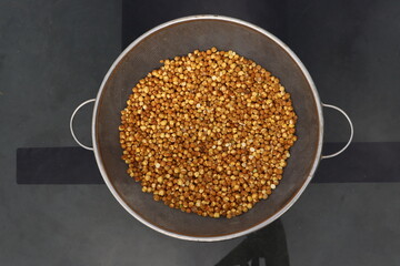Top shot of Brown Roasted Chickpeas or Roasted Kala Chana in a big metalic bowl