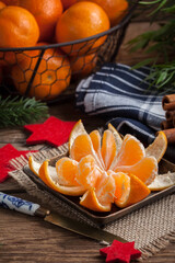 Peeled tangerine on the wooden table.