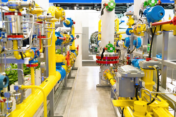 Gas equipment. Chemical factory interior. Yellow pipes for gas processing. Basement industrial...