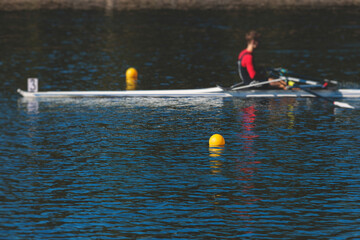 Group of rowing team athletes sculling during competition, kayak boats race in a rowing canal,...