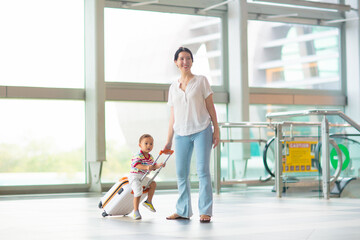 Family in airport. Kids fly. Travel with child.