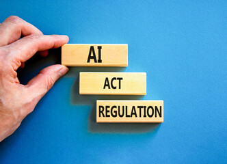 AI act regulation symbol. Concept words AI artificial intelligence act regulation on wooden block. Beautiful blue table blue background. Businessman hand. Business AI act regulation concept Copy space