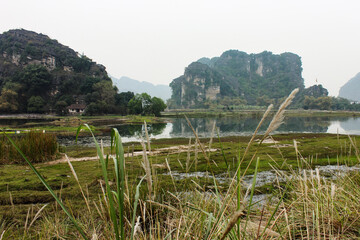 Fototapeta na wymiar lake with rice field and mountains, Vietnam