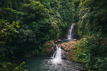 Multi-step waterfalls of the Seven Sisters Waterfalls surrounded by lush vegetation in Grand Etang...