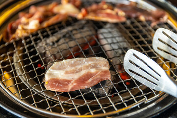 barbecue grilled on yakiniku stove which has hot charcoal. Barbecue Japanese style. Yakiniku. Is the Japanese version of Korean BBQ. Beef or Pork barbecue grilled on stove.