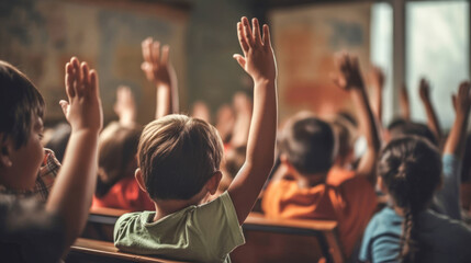 School children with hands up in classroom, view from back at the elementary school. Back to school. 