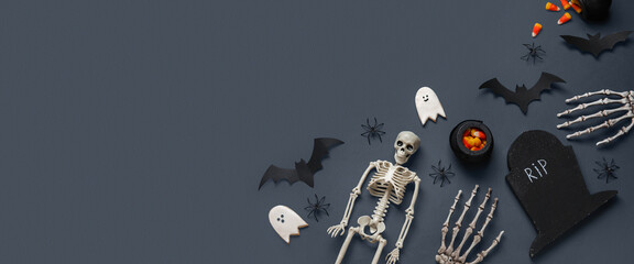 Composition with Halloween decor and candy corns on dark background with space for text