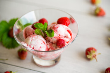 Balls of homemade strawberry ice cream in a bowl
