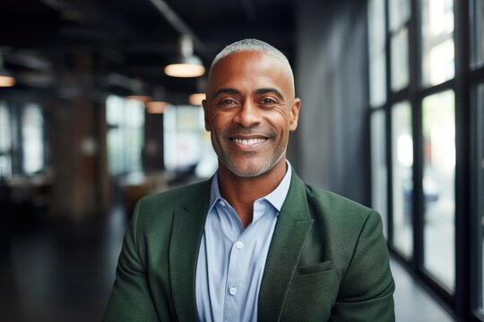 Portait of a middle aged businessman of african ethnicity in an office looking at camera
