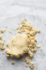 butter and flour being mixed together, butter and flour mixed into rough pastry, butter and flour being use to make cookie dough or pie dough, process of making cut out sugar cookies