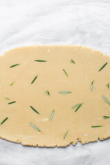 Top view of rolled out rosemary sugar cookie dough, process of making cut out sugar cookies