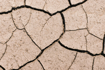 Dry, cracked earth. Drought. Lack of water for irrigation. Agricultural industry.The ground was cracks in the top view for the background or graphic design with the concept of drought .