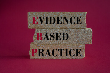 Text EBP Evidence-based practice concept on brick blocks. Beautiful red background. Business...