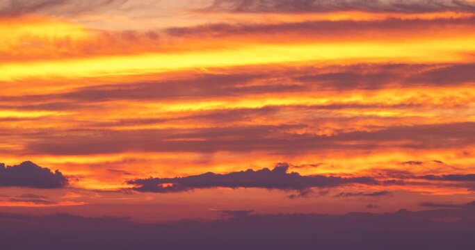 Sunrise timelapse, Sun is rising up in color sky clouds over sea horizon 4K video
