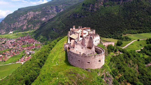 Castel Beseno aerial drone overflight in 4k - Most famous and impressive historical medieval castles of Italy in Trento province, Trentino region
