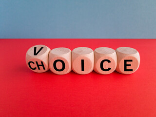 Voice and choice symbol. Turned wooden cubes and changed the concept word choice to voice. Beautiful red table, blue background, copy space. Business and voice and choice concept.