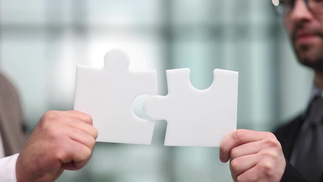 Partnership concept with hands putting jigsaw pieces together