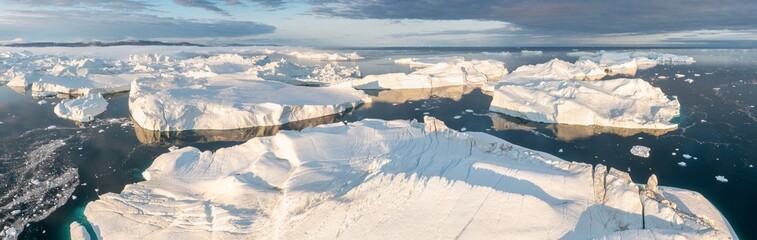 Glaciers drone aerial image from above - climate change and global warming. Glaciers from a melting iceberg in Ilulissat, Greenland. The icy landscape of the Arctic nature in the UNESCO world © Michal