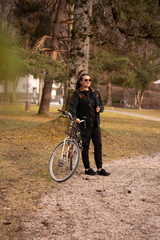 Fototapeta premium girl on a bike walking in a park