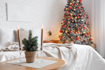 Interior of festive bedroom with Christmas tree