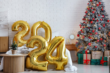 Balloons in shape of figure 2024 in festive bedroom with Christmas decor