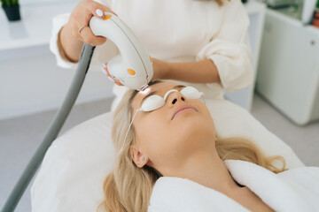 Closeup of medical, cosmetologically procedure for treatment of facial skin with light,...