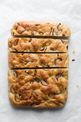 homemade onion focaccia on a white background, Flatlay of focaccia with red onion topping, fresh homemade focaccia bread