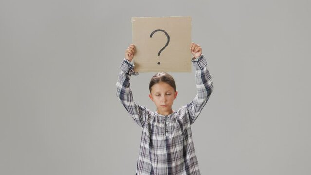 Question mark. Girl child holding a cardboard box