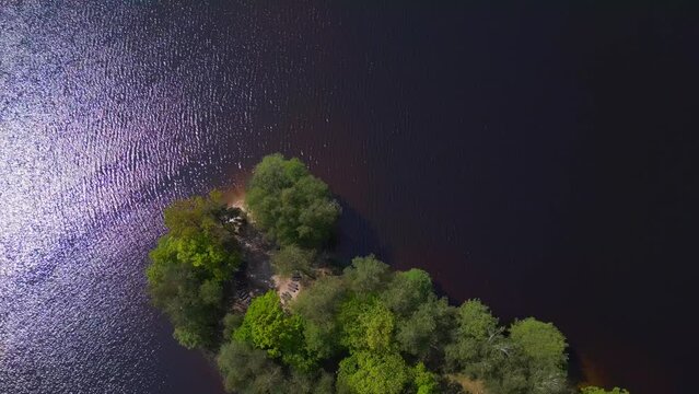 Stunning aerial top view flight drone. Summer Paradise Wooded Island in Lake