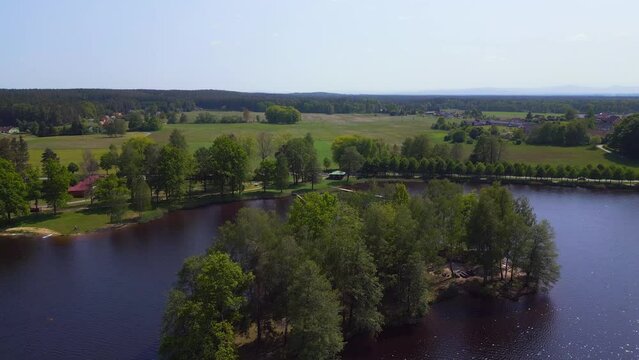 Dramatic aerial top view flight drone. Summer Paradise Wooded Island in Lake