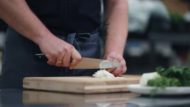 Chef Cooking On Kitchen Of Luxury Restaurant, Closeup View Of Hands With Knife On Chopping Board