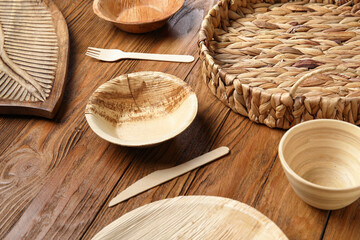 Different tableware on wooden background, closeup