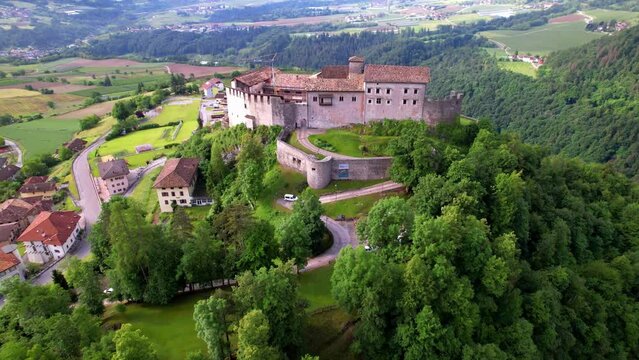 medieval castles of northern Italy. Castle Stenico and picturesque village. Trentino region, province of Trento. aerial drone overflight
