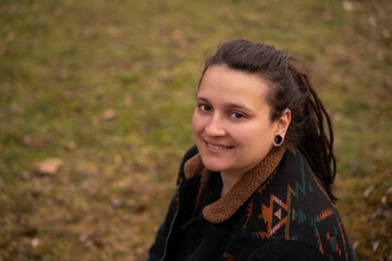 dreadlock brunette woman in a park