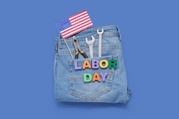 Jeans with different tools, USA flag and text LABOR DAY on blue background