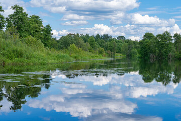 summer landscape with river, road and clouds in the blue sky